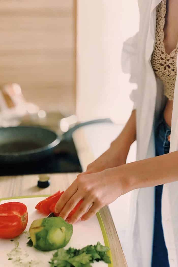 woman chopping veggies in the kitchen