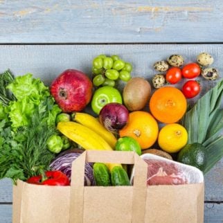 grocery bag with healthy foods coming out the top