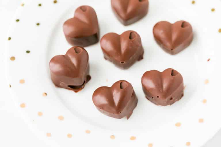 plate with several dark chocolate hearts on it