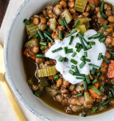 Instant Pot lentil soup in a bowl with a gold spoon