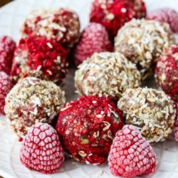 Coconut Raspberry CBD Energy Bites on plate close-up with raspberries