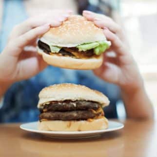 woman eating a cheeseburger