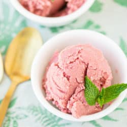 bowl of pink ice cream with mint on top