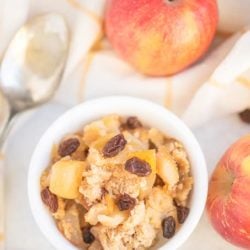 cobbler in a bowl with apples and a spoon