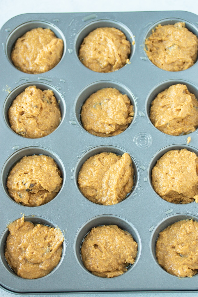muffin batter in the muffin tin ready to be baked