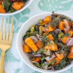 bowl of sweet potato kale casserole with gold forks