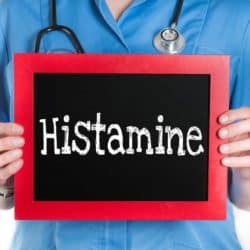 woman holding a sign that says histamine