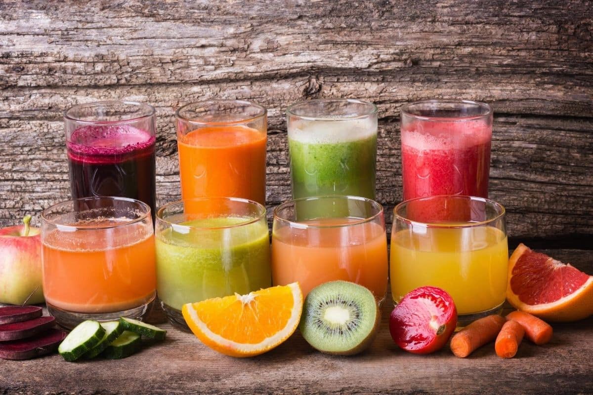 fresh juices lined up on a countertop.