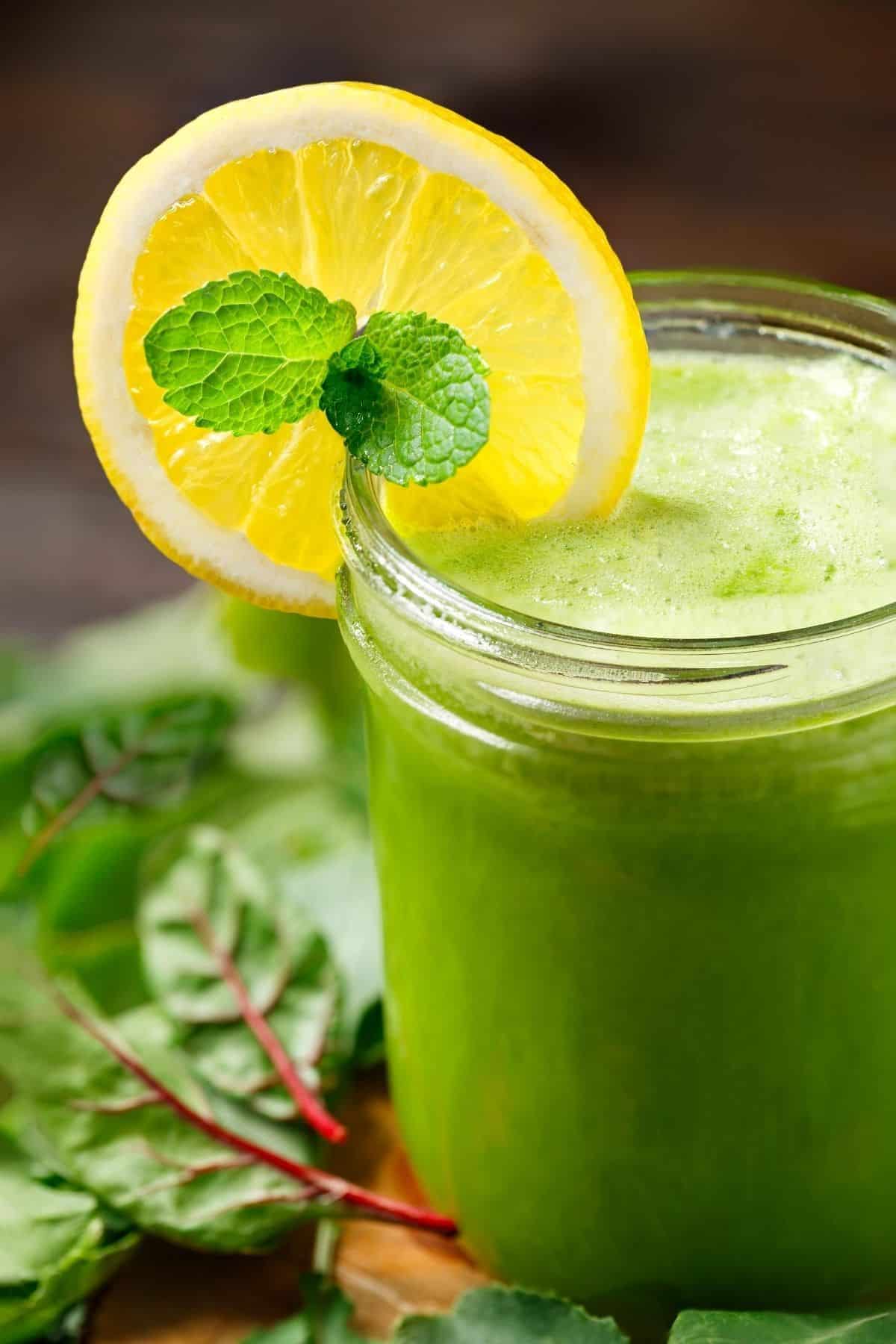 green juice with a slice of lemon on the glass