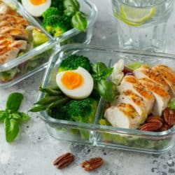 meal prepped chicken dish with veggies and egg.