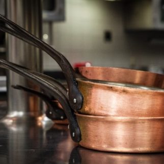 Copper pans stacked on Stove