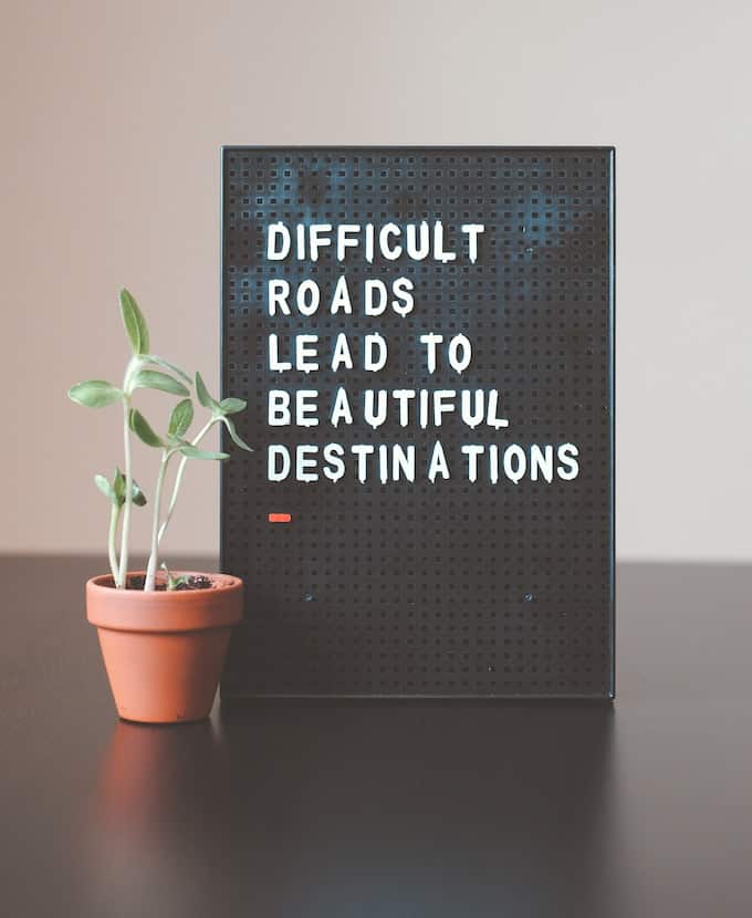 sign that says difficult roads lead to beautiful destinations