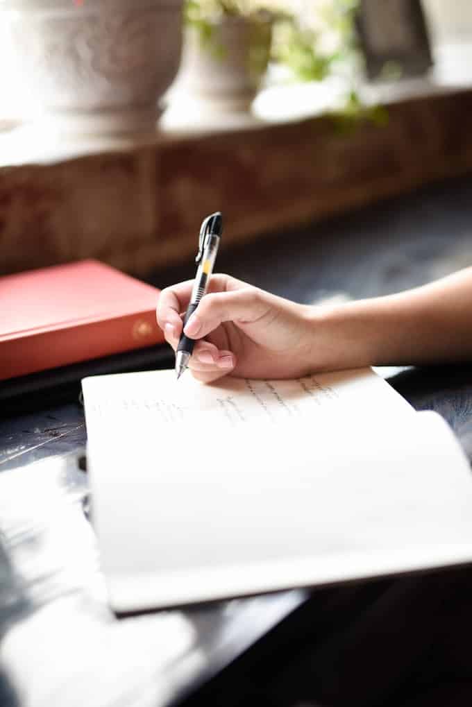 woman writing in a journal