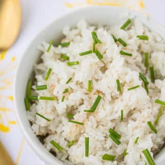 bowl of cooked white rice with chives on top