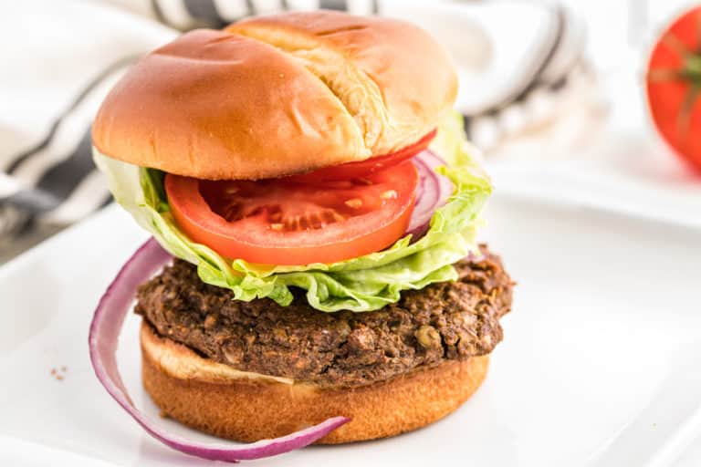 lentil burger served on a bun with tomato