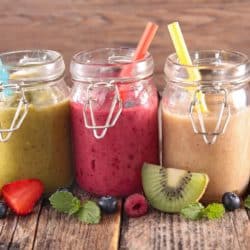 three smoothies ready to drink out of jars