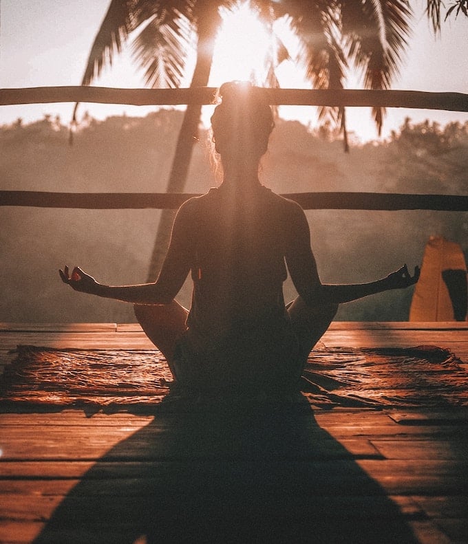 woman meditating outdoors.