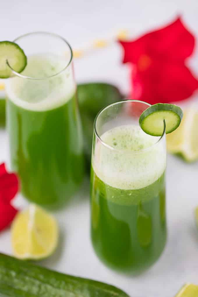 cucumber juice in two glasses with cucumber and lime slices