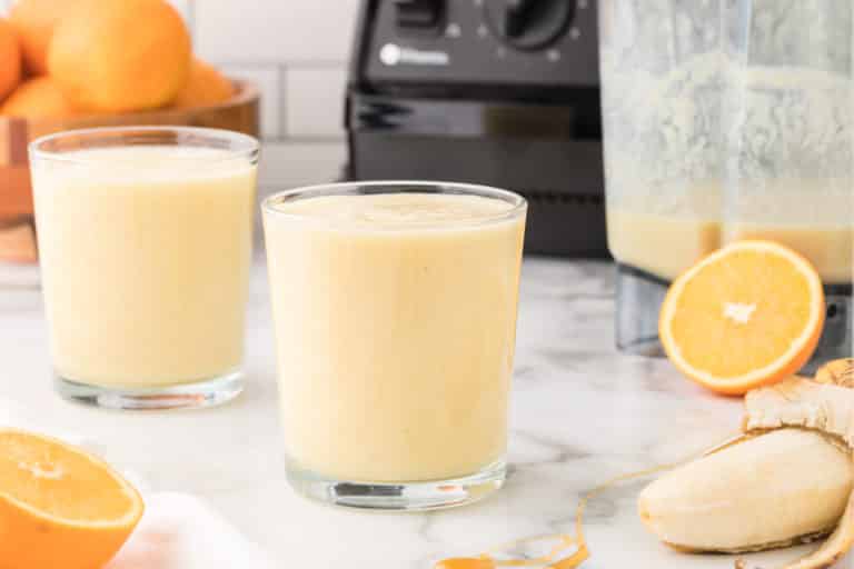 orange banana smoothie in two glasses.