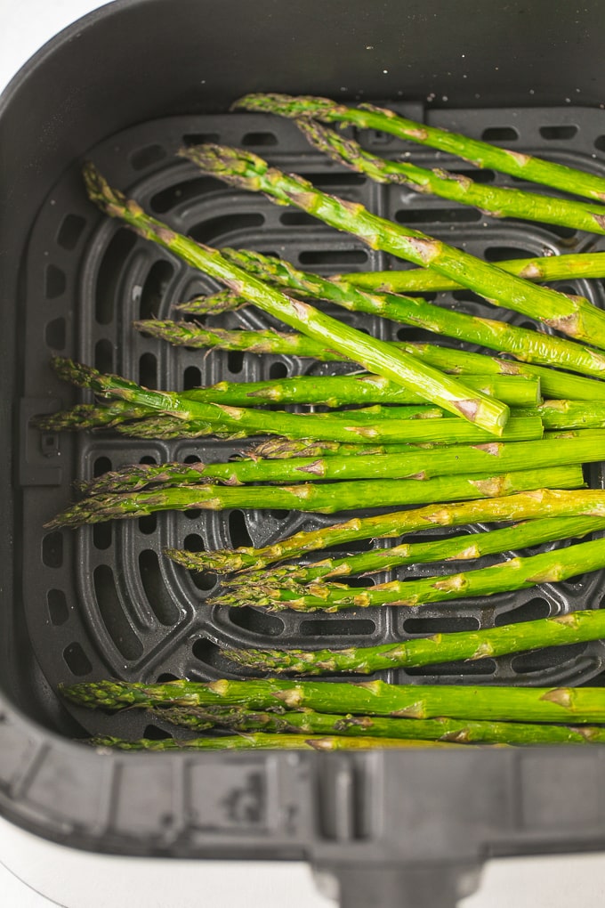 asparagus in the basket of an air fryer
