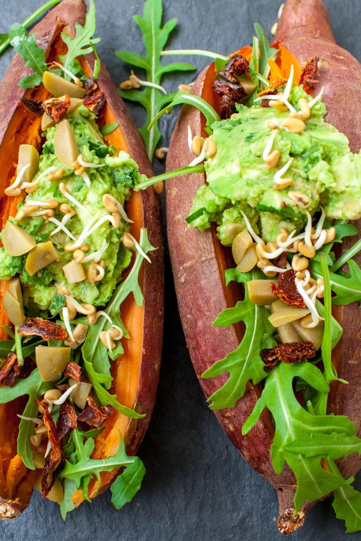 cooked sweet potatoes with guacamole on top.