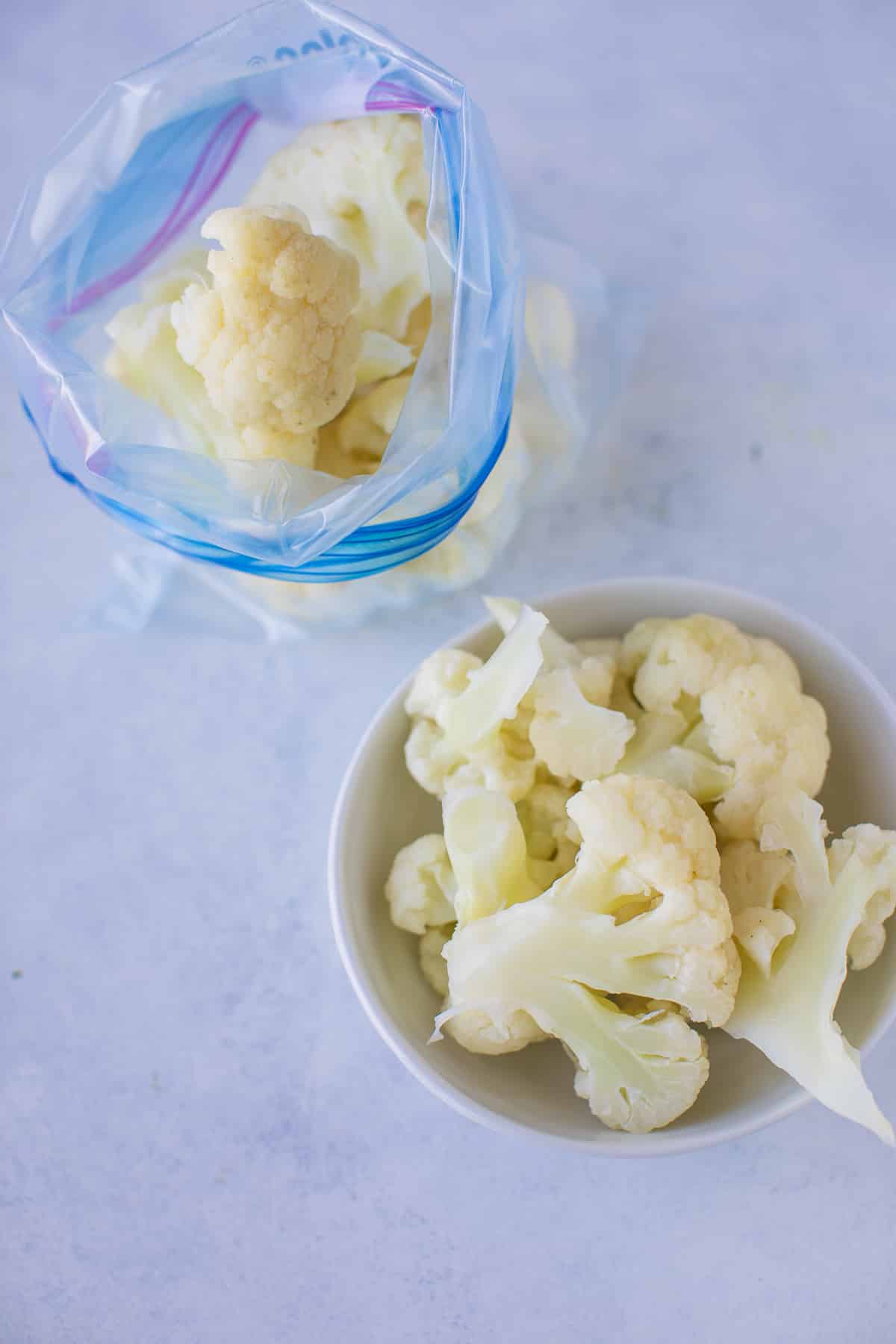 frozen cauliflower florets in a bag and a bowl