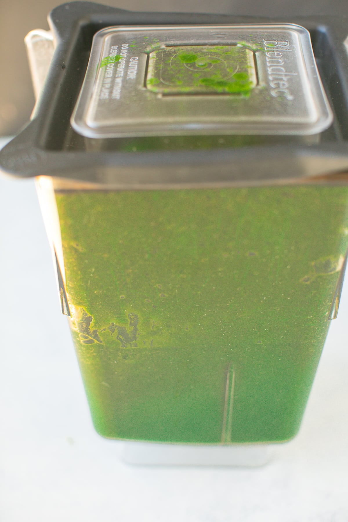pureed greens in the base of a high speed blender