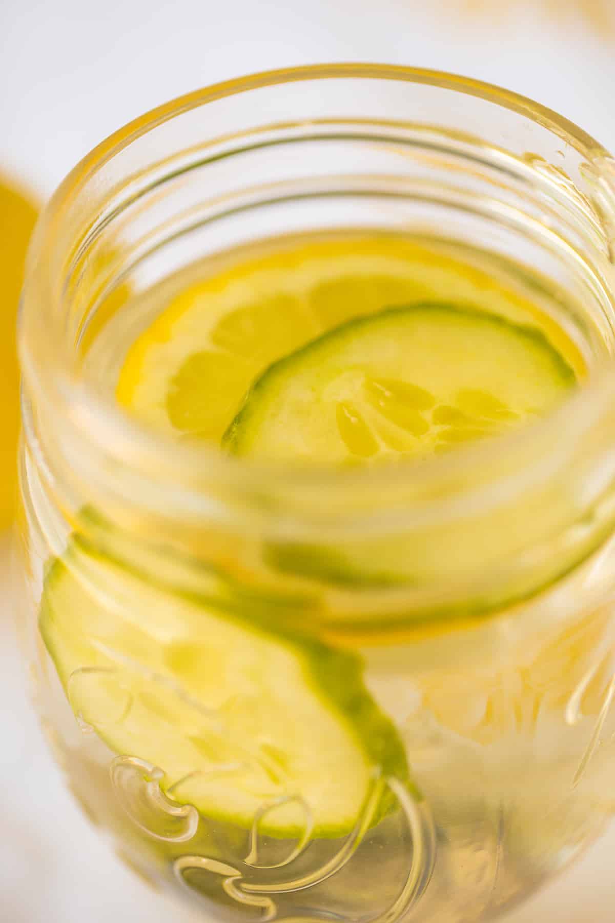 ball jar with water and sliced lemons and cucumbers