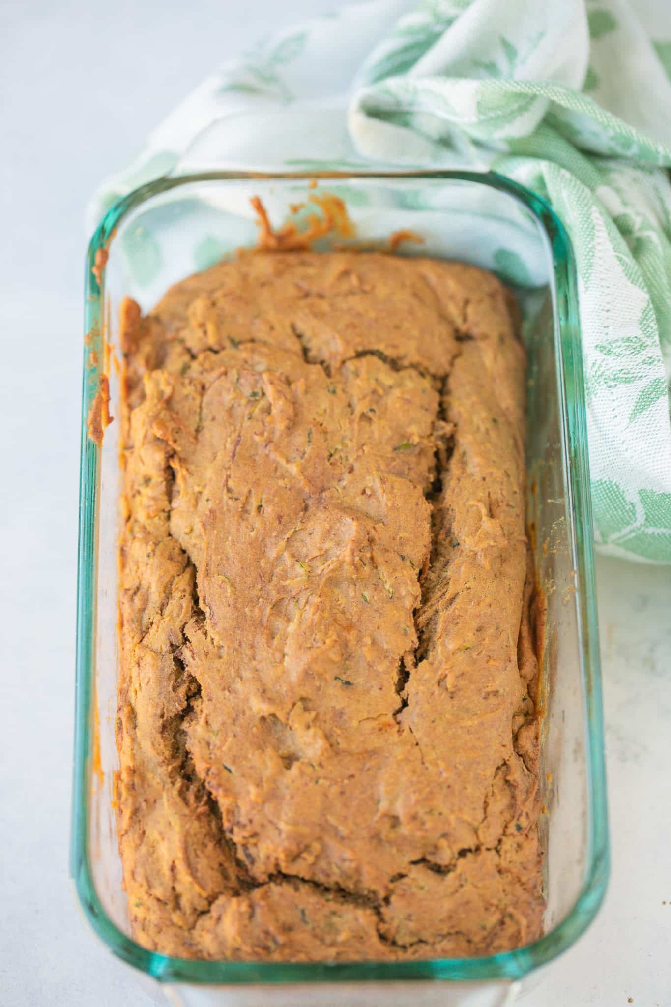 baked zucchini bread cooling in glass baking dish