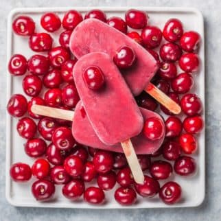 plate with cherry popsicles.