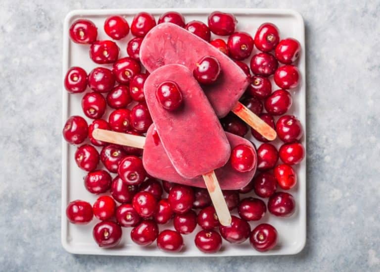plate with cherry popsicles.
