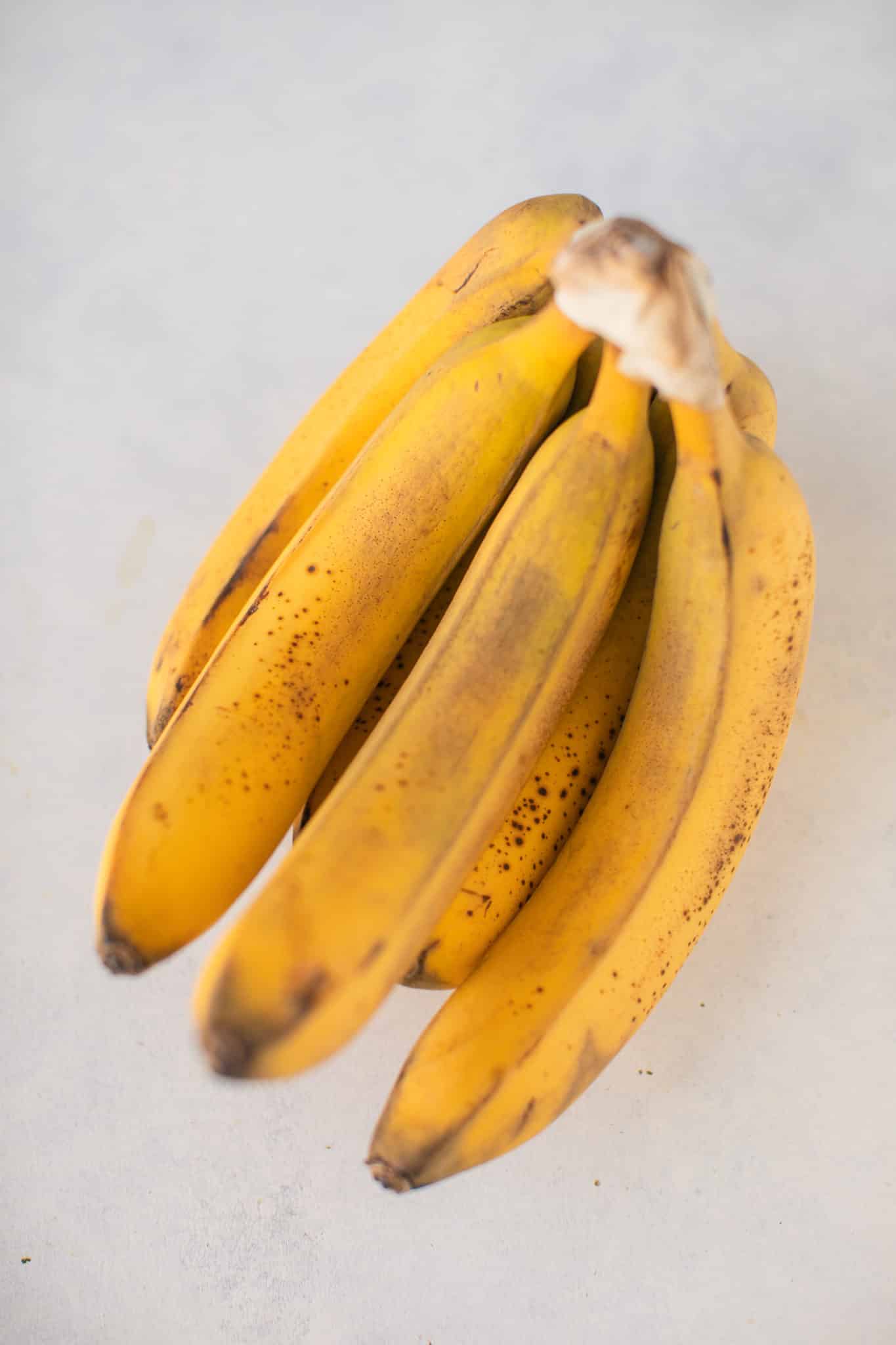 bunch of ripe bananas on a white background