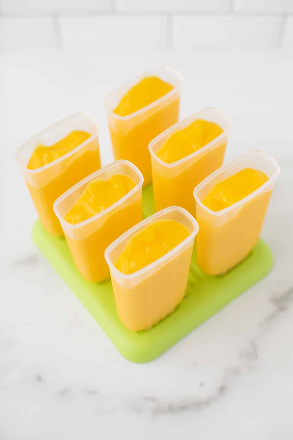 mango mixture in popsicle molds