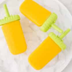 bowl with three mango popsicles