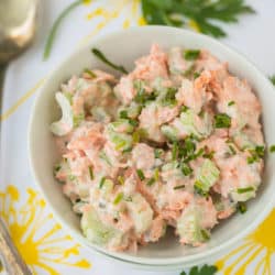 bowl of salmon salad with antique serving spoons