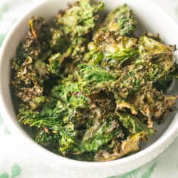 kale chips in a white bowl ready to be eaten