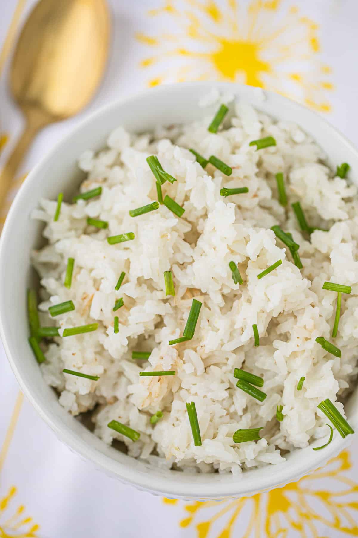 bowl of instant pot coconut rice with chopped chives on top