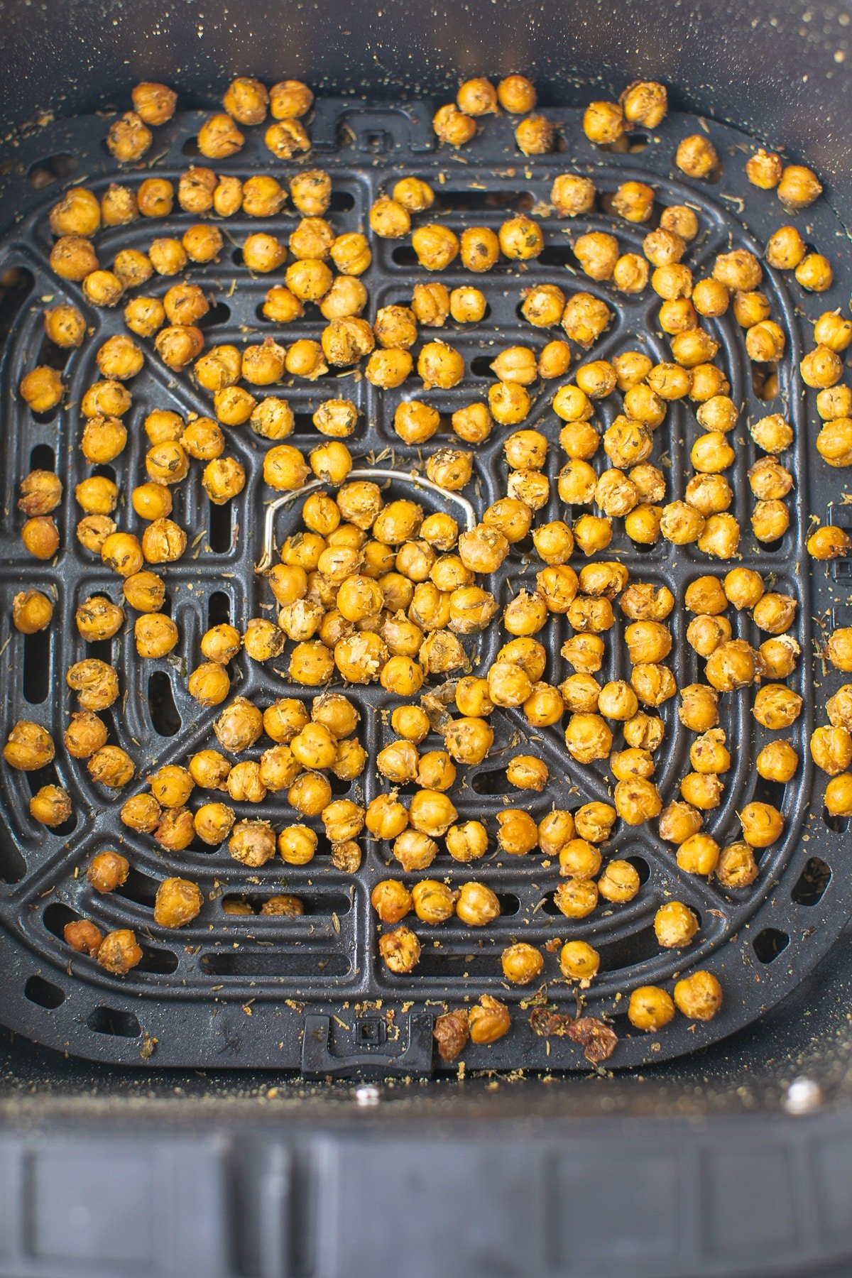 roasted chickpeas in the basket of an air fryer.
