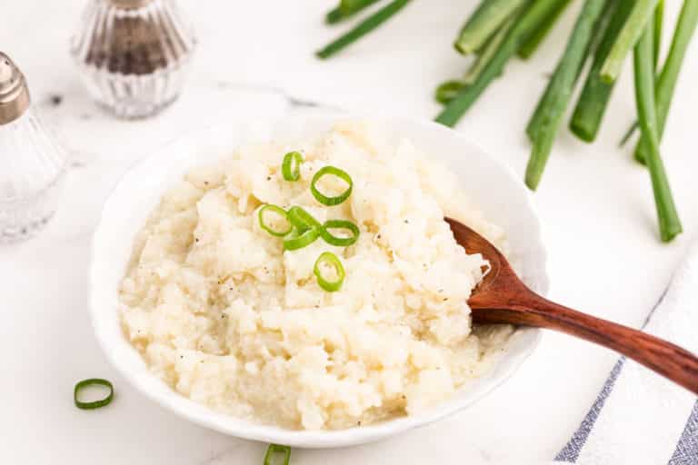 bowl of instant pot mashed cauliflower with spoon