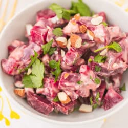 bowl of beet salad with a sprinkle of fresh cilantro on top