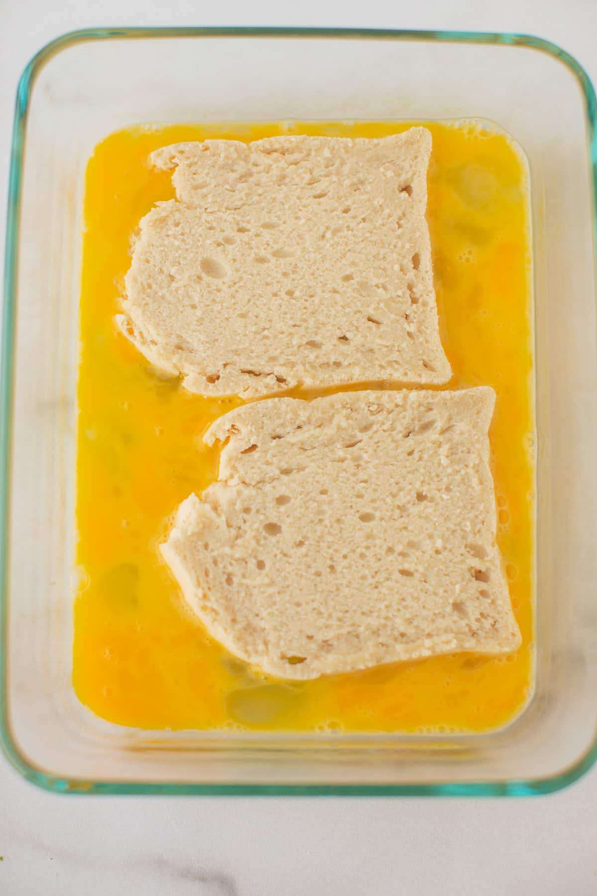 bread soaking in egg mixture for french toast