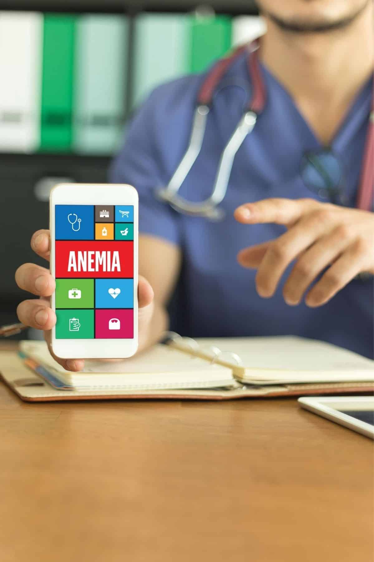 doctor holding up phone that says anemia.