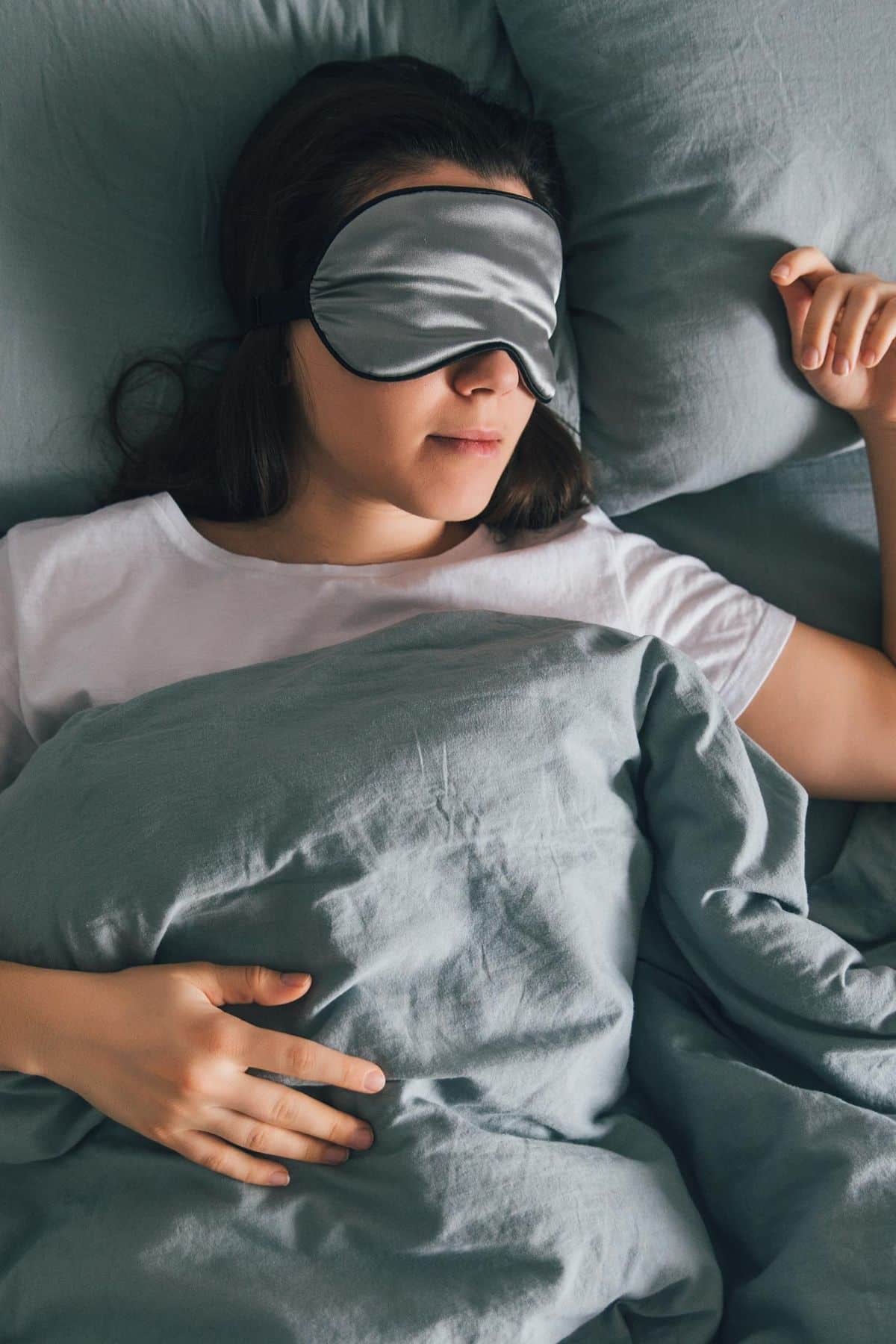 woman sleeping in bed with an eye mask.