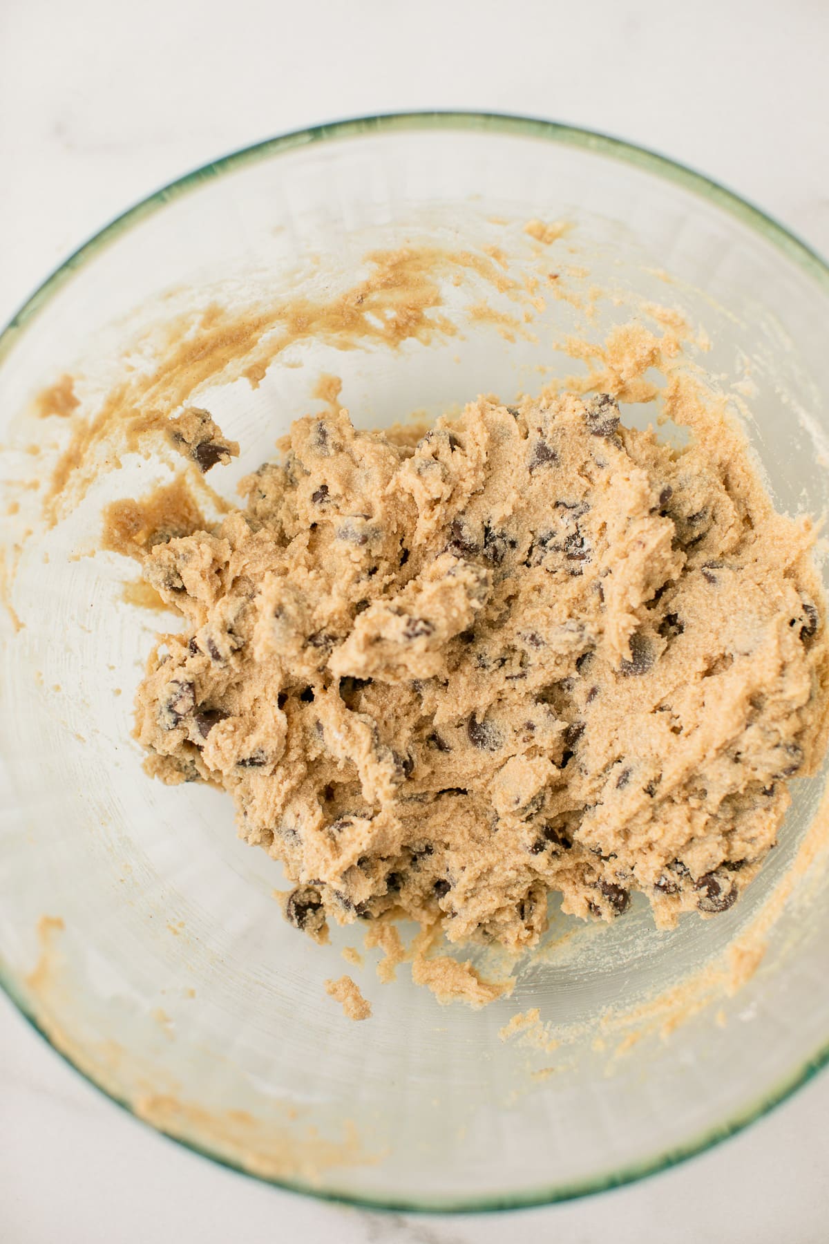 cassava flour cookie ingredients mixed together in a glass mixing bowl.