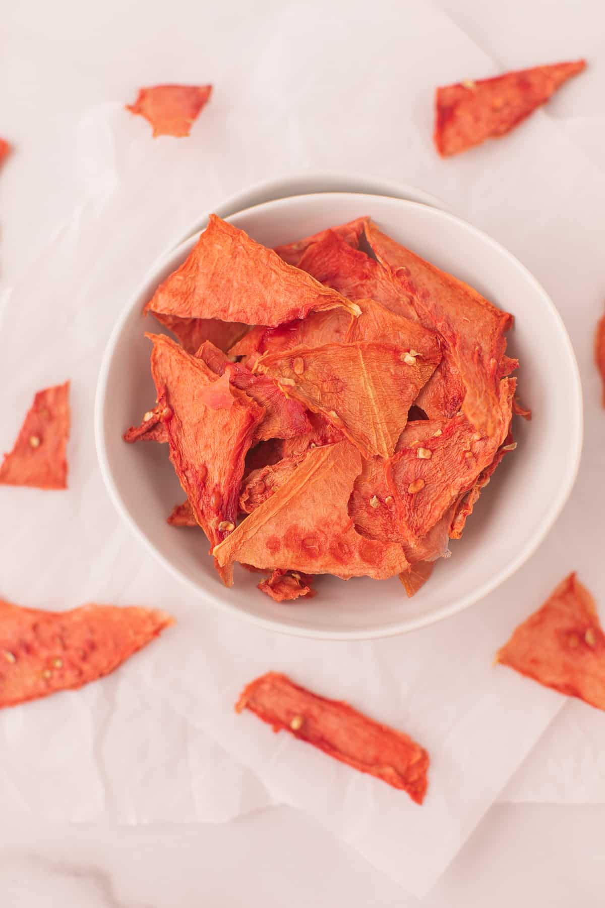 bowl of dehydrated watermelon jerky in a white bowl.