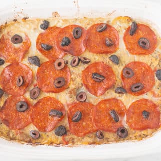 pizza casserole in a white baking dish ready to be served