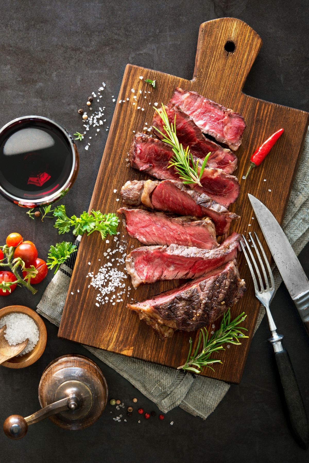 steak dinner sliced on a cutting board.