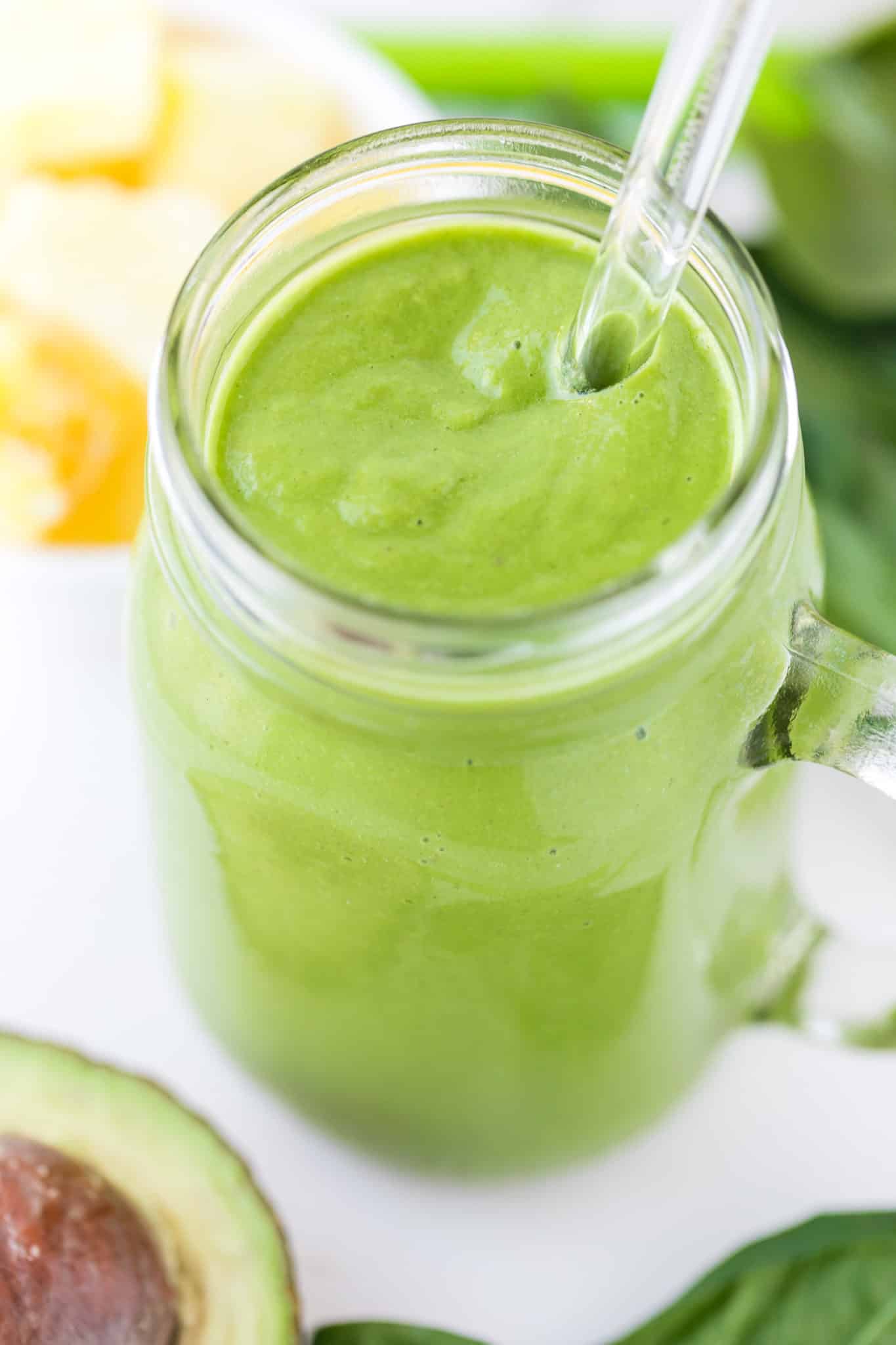 blended green smoothie served in a glass jar