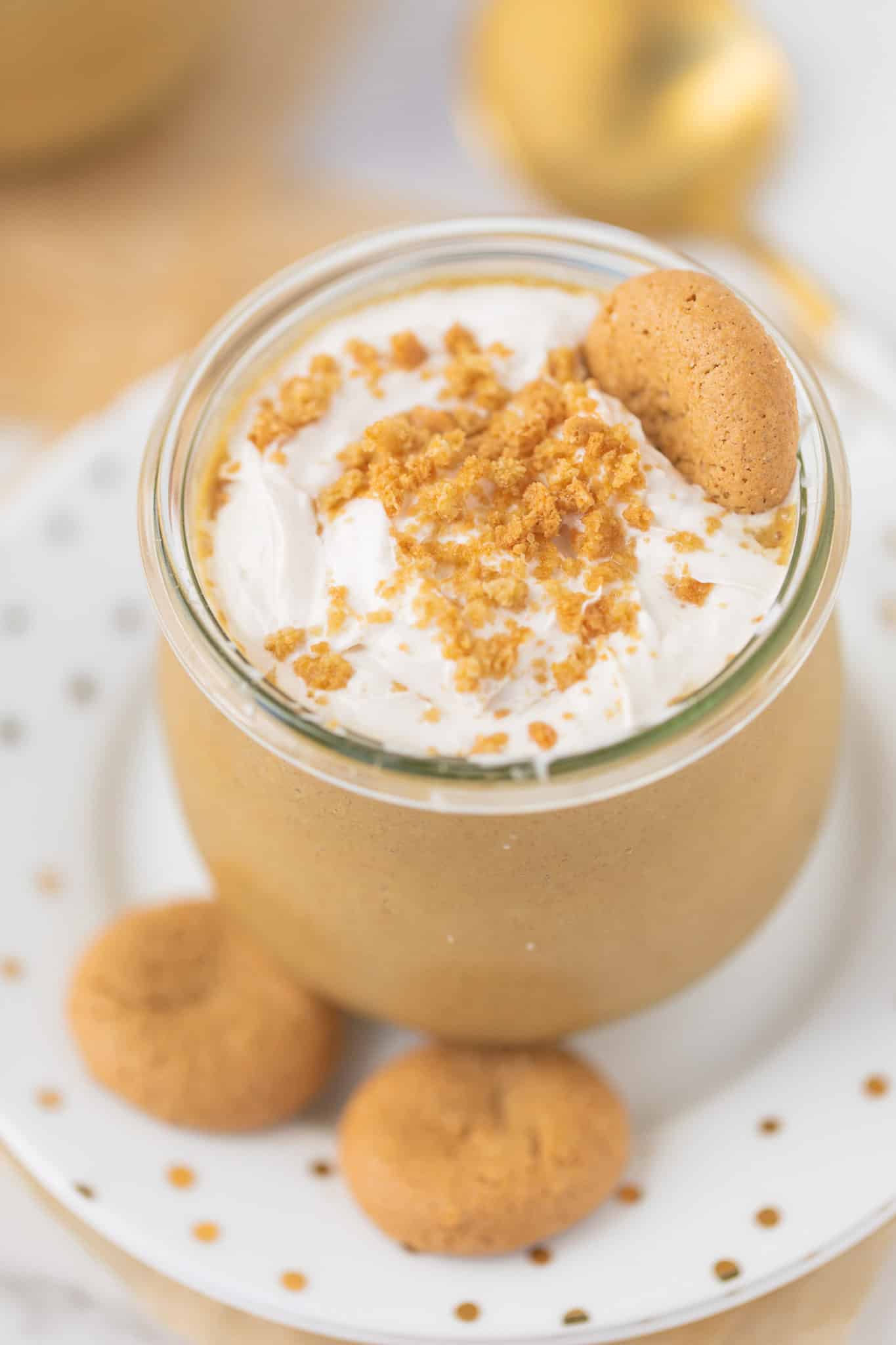 vegan gingerbread smoothie served in a jar with whipped cream and cookies
