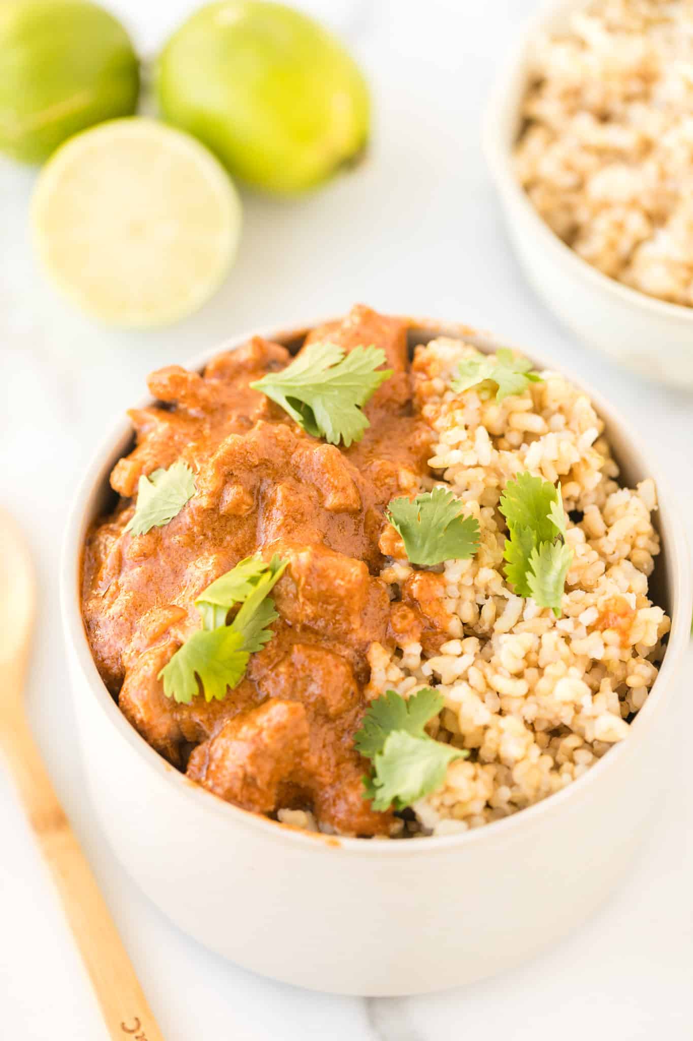 instant pot peanut chicken served with brown rice in a bowl